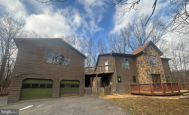 view of front of property featuring a deck and a garage