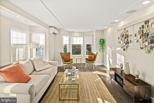 living room with an AC wall unit and dark hardwood / wood-style floors