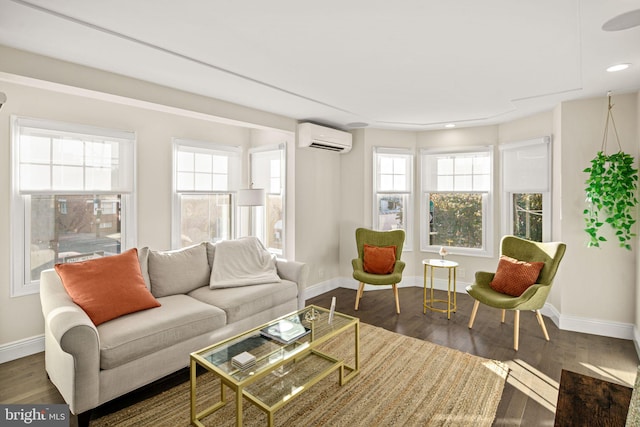 living room with plenty of natural light, dark hardwood / wood-style flooring, and a wall unit AC