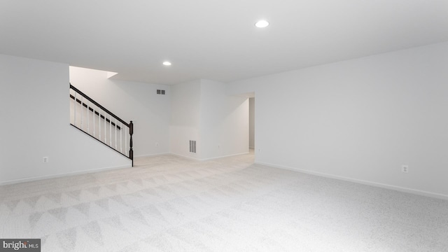 unfurnished room featuring light colored carpet