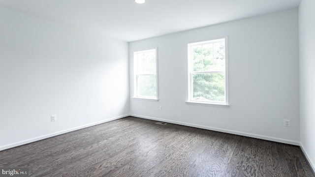 unfurnished room with dark hardwood / wood-style floors