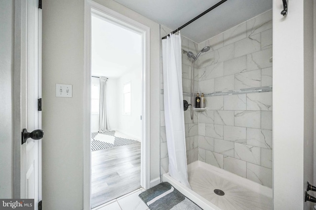 bathroom featuring wood-type flooring and walk in shower