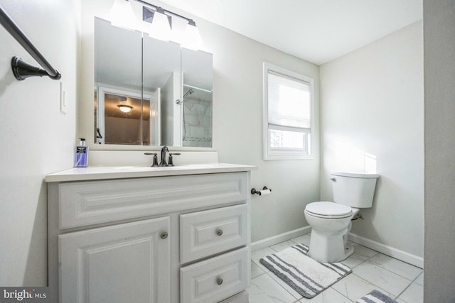 bathroom featuring vanity, toilet, and walk in shower