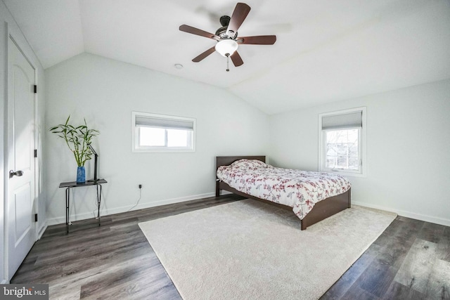 bedroom featuring dark hardwood / wood-style floors, ceiling fan, and lofted ceiling