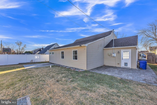 back of property featuring a patio and a lawn