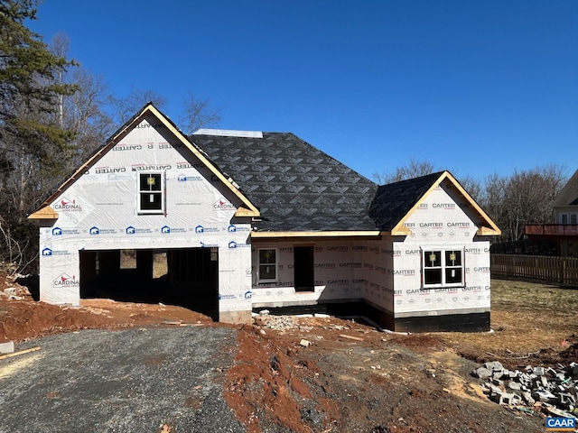 property in mid-construction featuring fence, a garage, and driveway