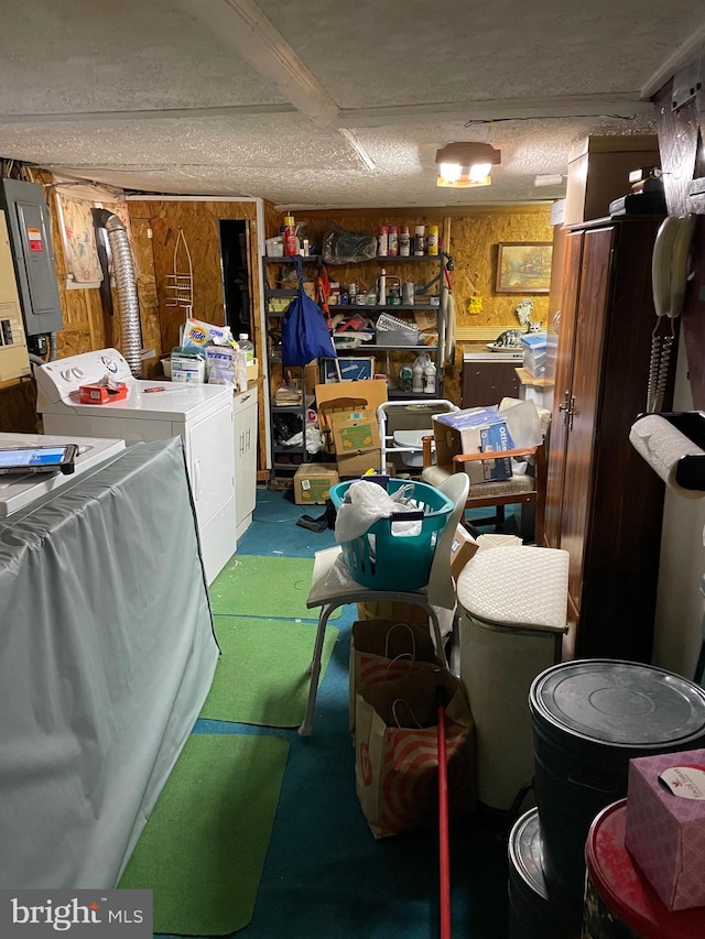 interior space featuring separate washer and dryer, wood walls, and electric panel