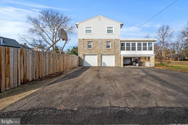 exterior space with a sunroom and a garage