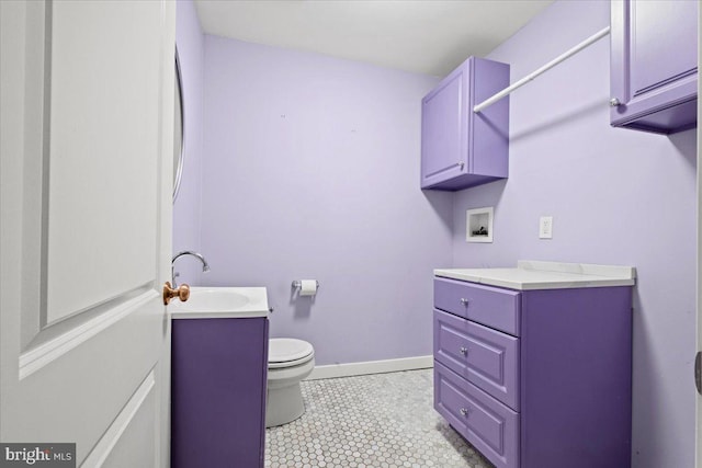 bathroom featuring tile patterned flooring, vanity, and toilet