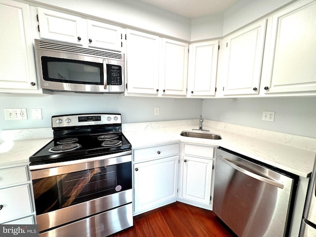 kitchen with white cabinets, dark hardwood / wood-style floors, sink, and stainless steel appliances