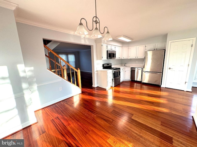 kitchen with white cabinetry, dark wood-type flooring, pendant lighting, and appliances with stainless steel finishes