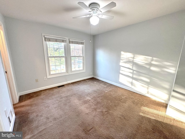 carpeted spare room with ceiling fan