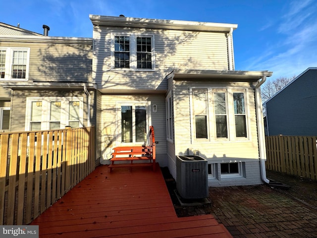 rear view of property with cooling unit