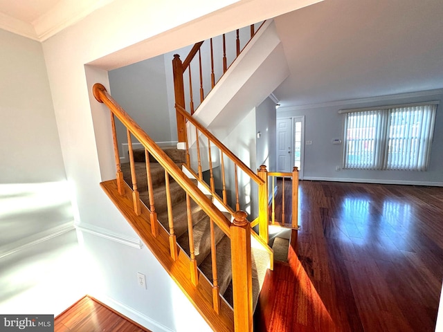 stairway featuring hardwood / wood-style flooring and crown molding