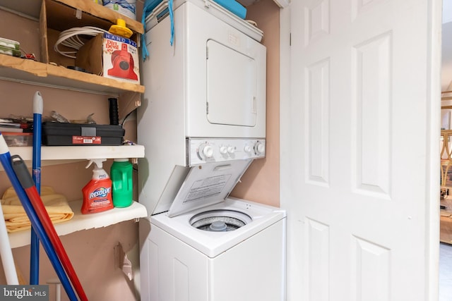 laundry area with stacked washing maching and dryer