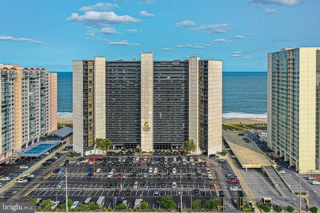 view of property featuring a view of the beach and a water view