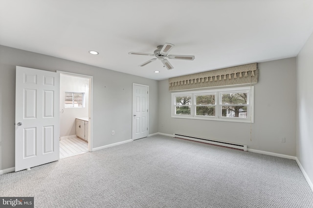 unfurnished bedroom featuring ceiling fan, baseboard heating, ensuite bath, and carpet flooring