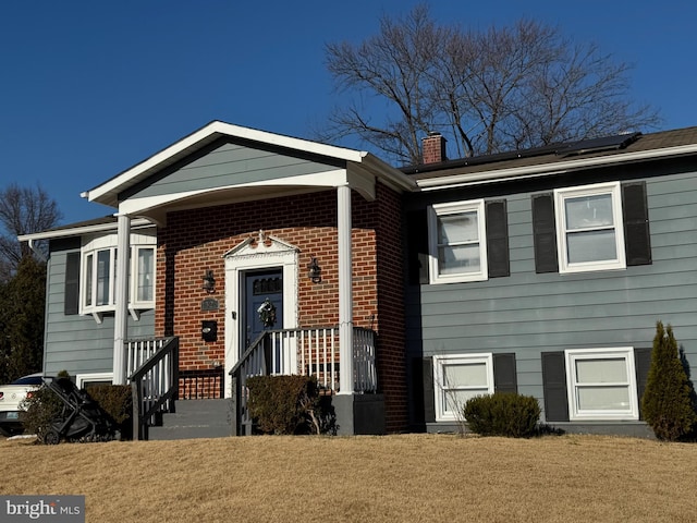 view of front facade featuring solar panels