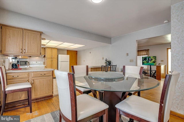 dining space with light hardwood / wood-style flooring