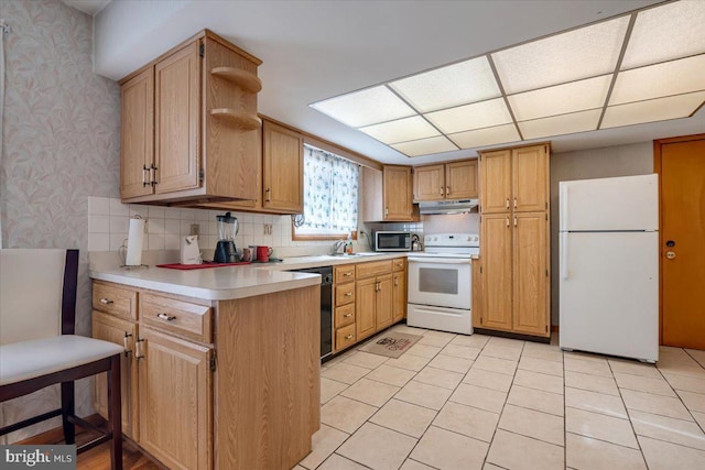 kitchen with decorative backsplash, light tile patterned flooring, and white appliances