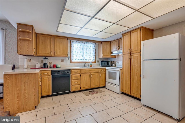 kitchen with kitchen peninsula, white appliances, and tasteful backsplash