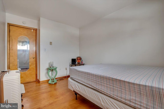 bedroom with hardwood / wood-style floors