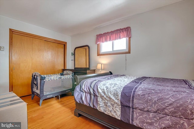 bedroom with light hardwood / wood-style flooring and a closet