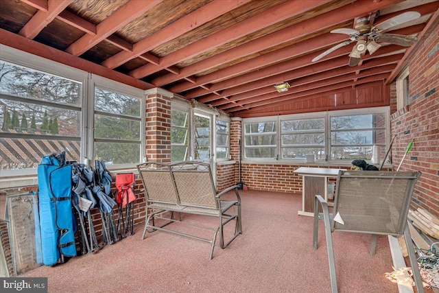 sunroom / solarium featuring vaulted ceiling with beams and ceiling fan