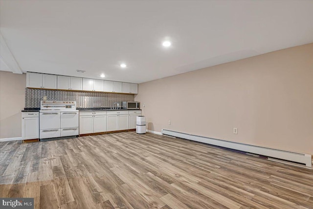 kitchen featuring white electric range, light wood-type flooring, white cabinetry, and a baseboard heating unit