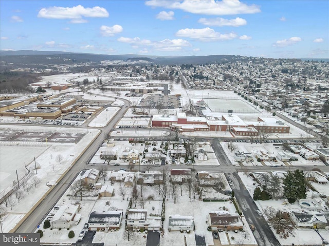 snowy aerial view with a mountain view