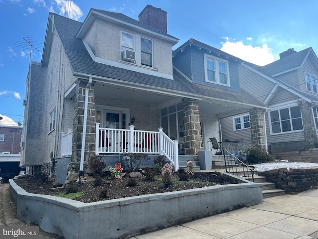 view of front of property featuring cooling unit and a porch