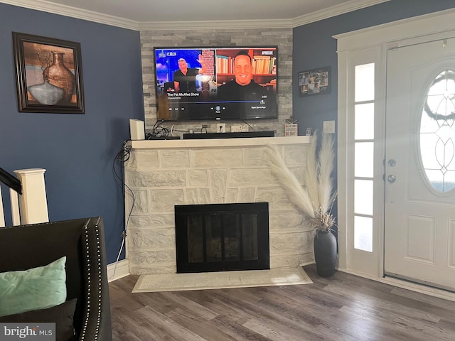 interior space with hardwood / wood-style flooring, a fireplace, and ornamental molding