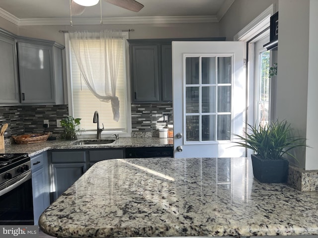 kitchen featuring backsplash, gray cabinets, and sink