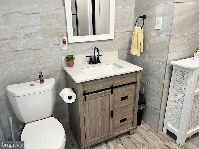 bathroom with radiator heating unit, vanity, and toilet