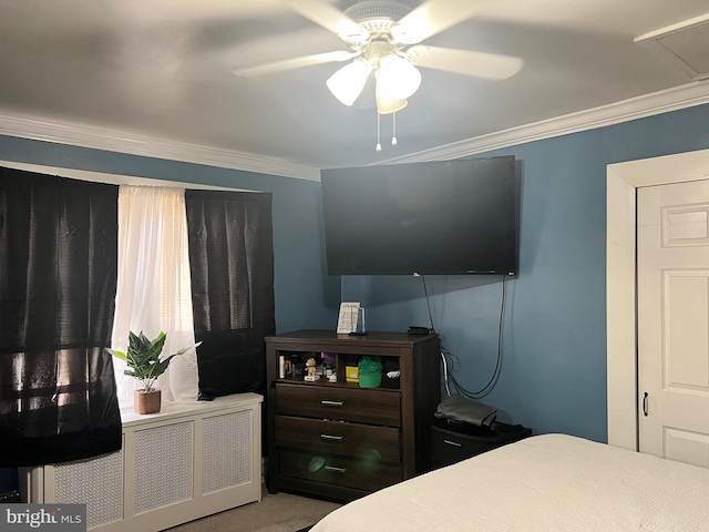 carpeted bedroom with ceiling fan, radiator heating unit, and ornamental molding