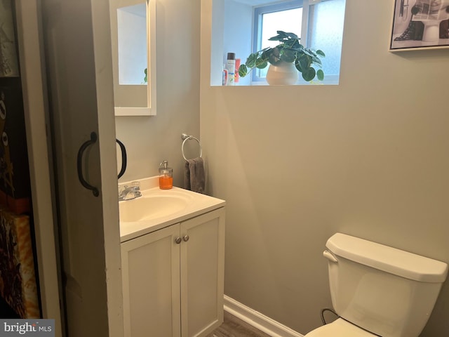 bathroom featuring vanity and toilet