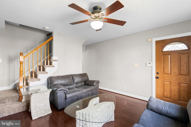 living room with ceiling fan and dark wood-type flooring