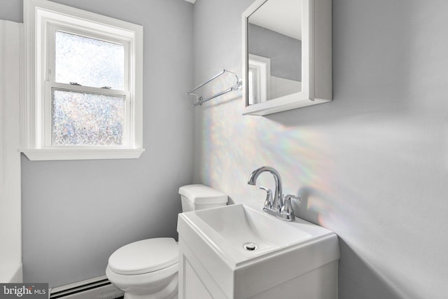 bathroom with baseboard heating, sink, and toilet