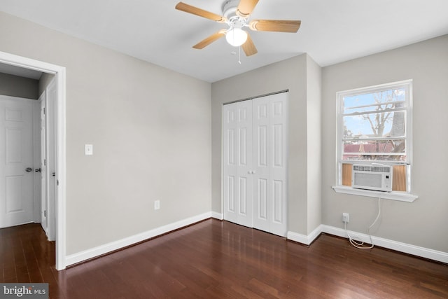 unfurnished bedroom with ceiling fan, a closet, and dark wood-type flooring