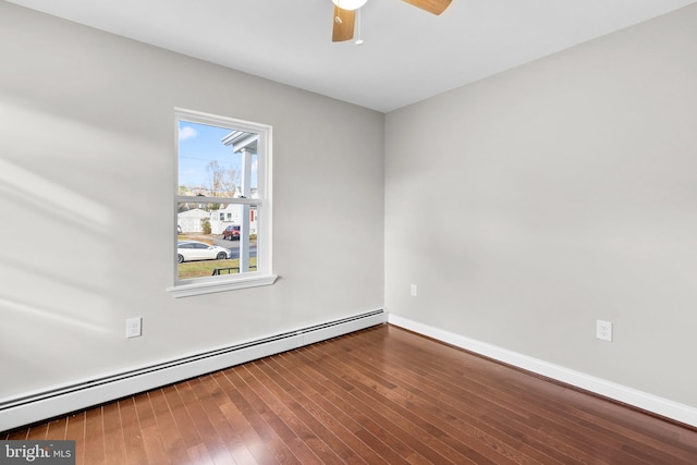 empty room featuring ceiling fan, wood-type flooring, and baseboard heating