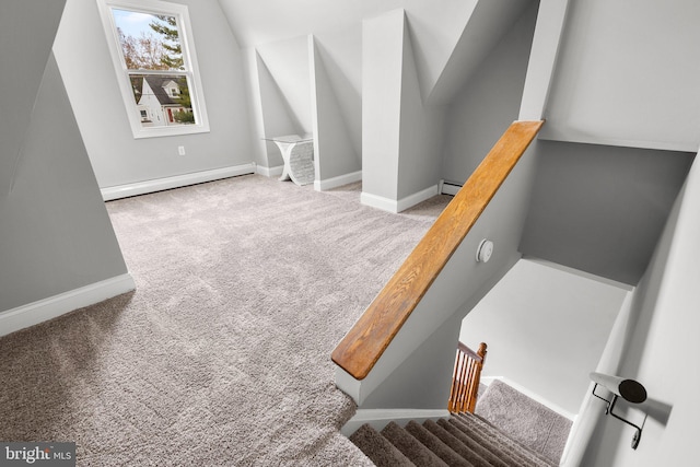 stairs featuring lofted ceiling, carpet floors, and a baseboard radiator