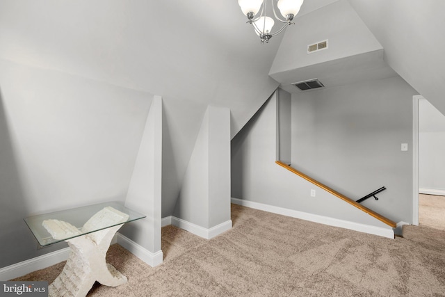 stairs featuring carpet flooring, lofted ceiling, and a notable chandelier