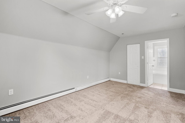 bonus room with light carpet, vaulted ceiling, baseboard heating, and ceiling fan