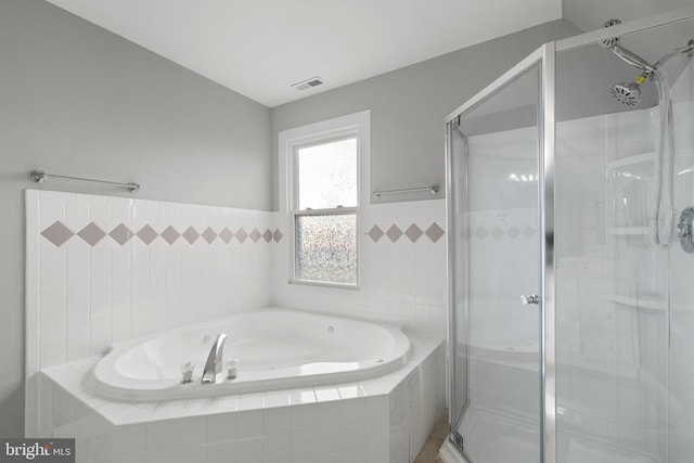 bathroom featuring plus walk in shower and lofted ceiling