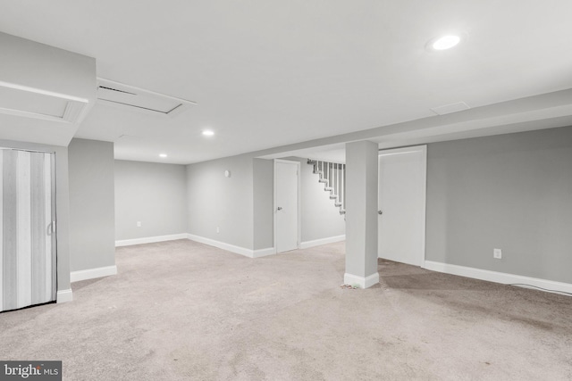 basement featuring light colored carpet