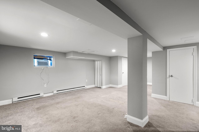 basement featuring light carpet, a wall unit AC, and a baseboard radiator