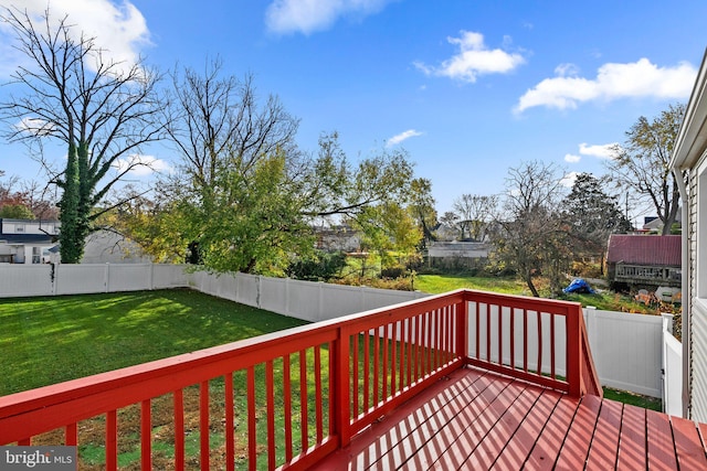 wooden terrace with a lawn