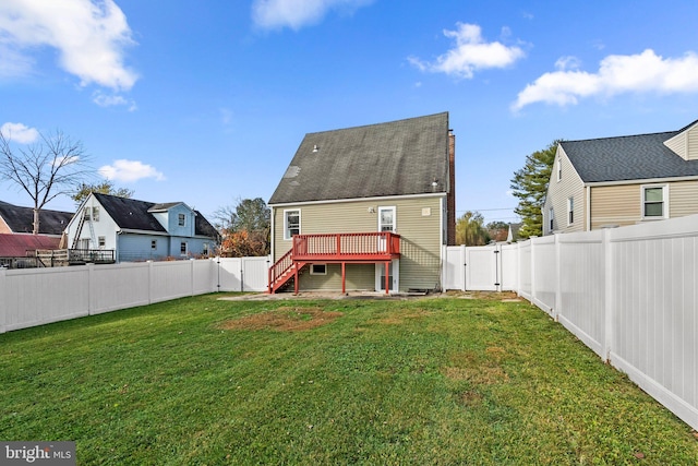 back of property with a lawn and a wooden deck