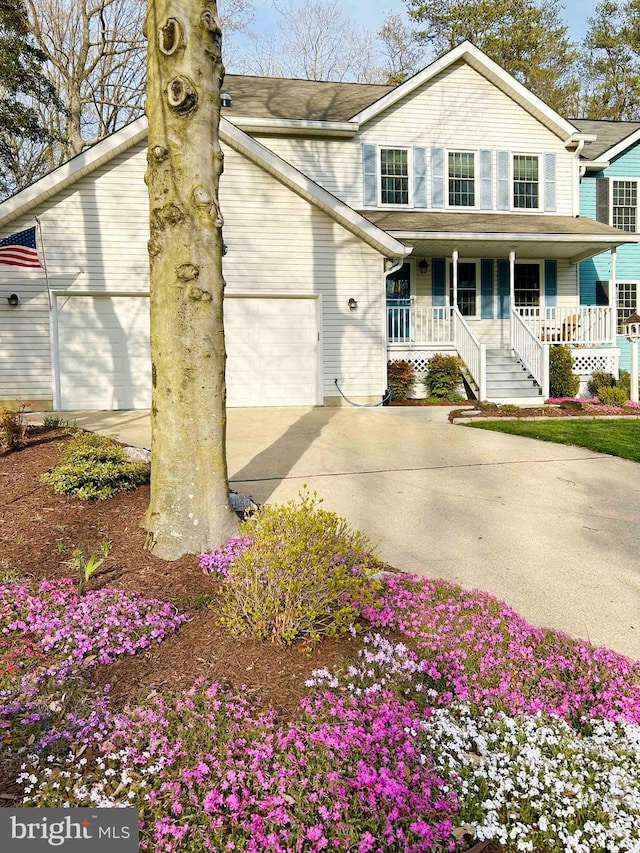 view of front of house with a porch and a garage