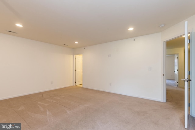 unfurnished room featuring light carpet